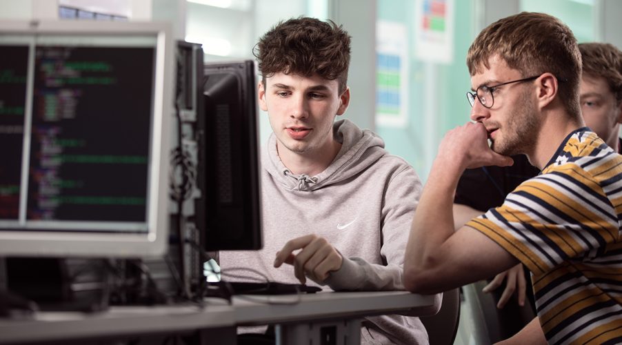 Digital technology students working on a computer