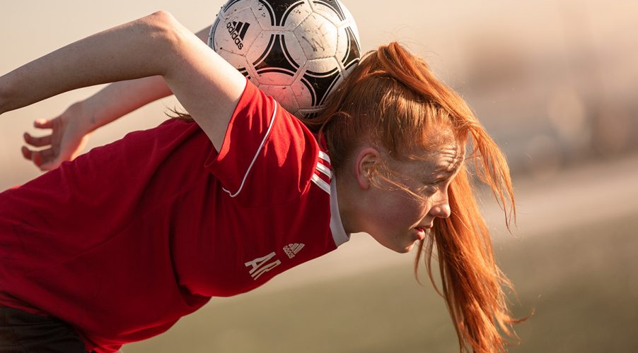 Women's football player practicing