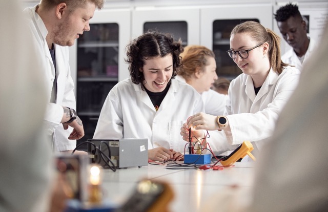 group of science students performing experiment